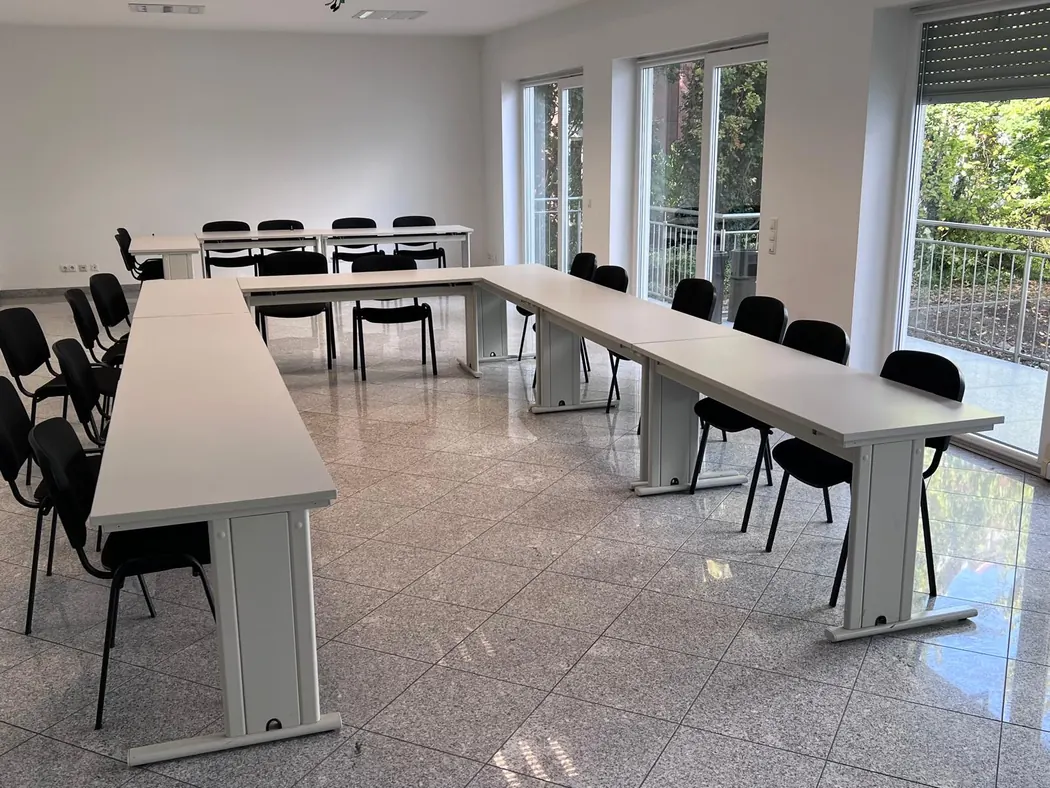 Heller Schulungsraum mit U-förmiger Tischanordnung